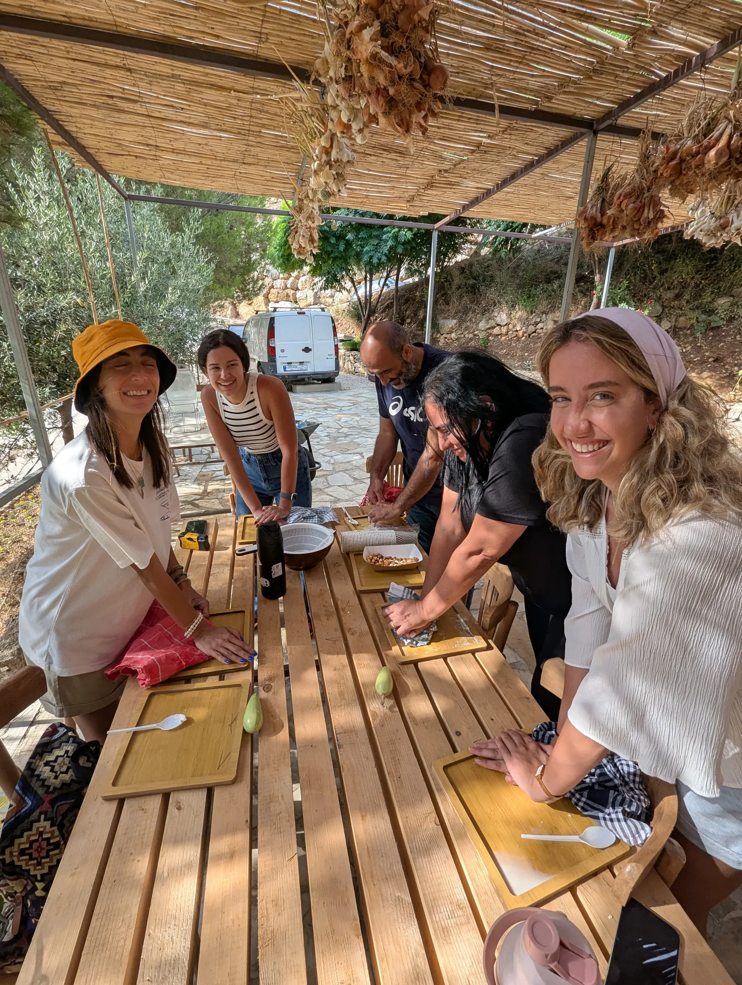 Visitors gathering around a farm table at Sannour