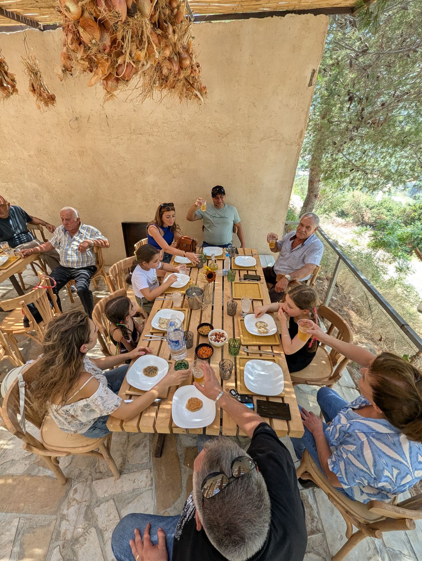 Members gathering around a shaded farm table at Sannour