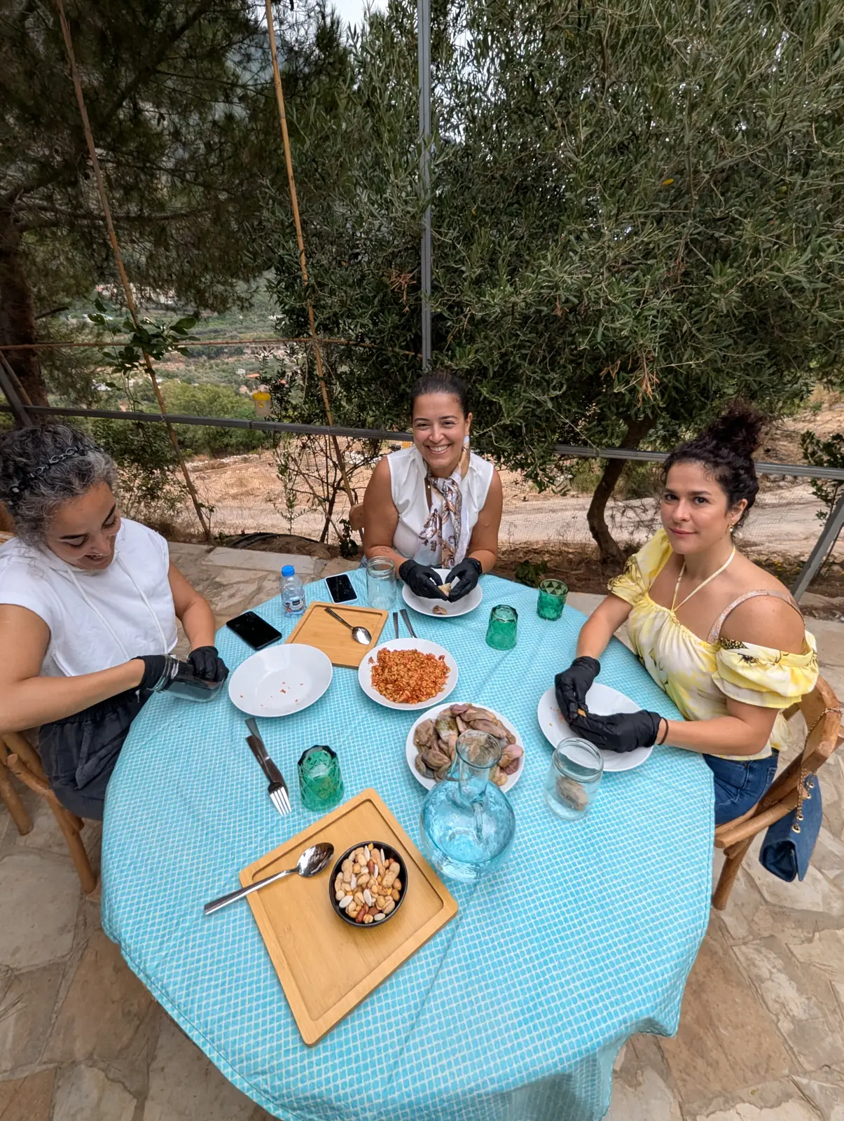 Families sharing food around a farm table at Sannour