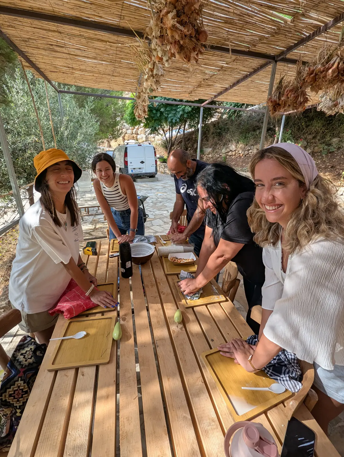 Visitors learning together around a farm table at Sannour